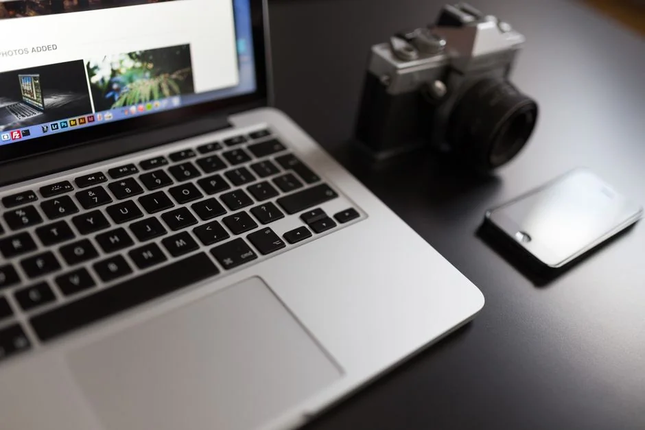 our-story A tidy desk setting with a laptop showing a stock photo website and a smartphone.
